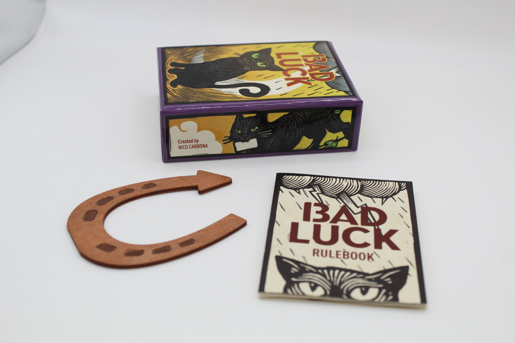 Bad Luck box, rulebook and horseshoe